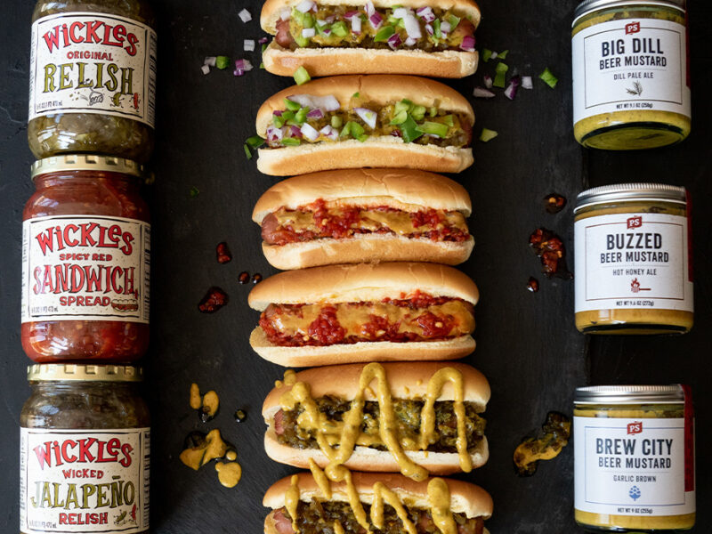 Wickles and PS Seasoning Collab Wickedly Delicious Hot dogs topped with wickles and ps seasoning