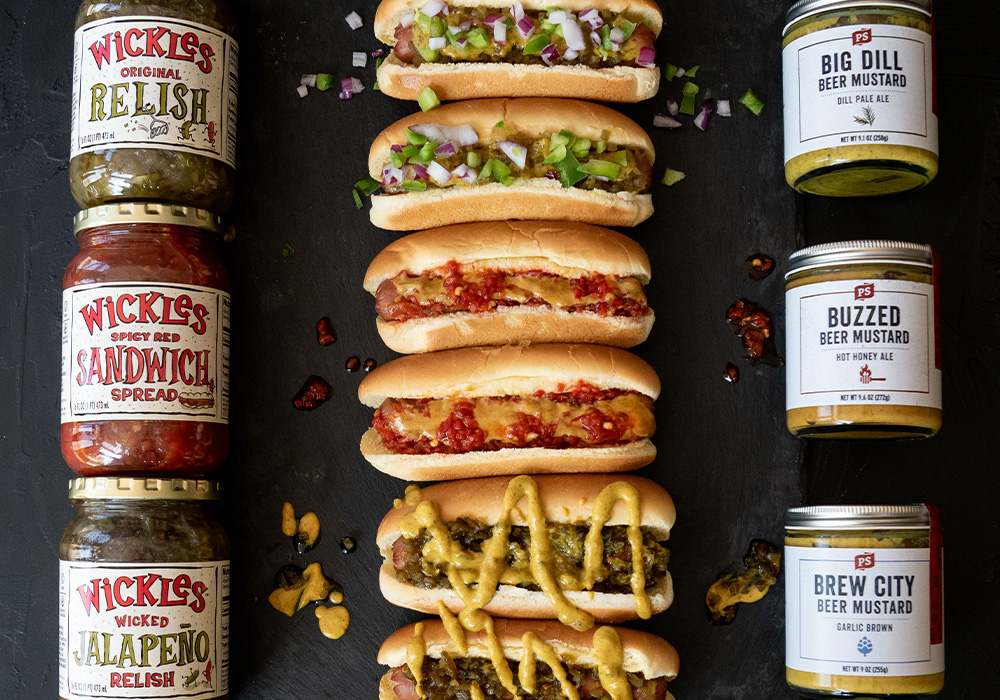 Wickles and PS Seasoning Collab Wickedly Delicious Hot dogs topped with wickles and ps seasoning